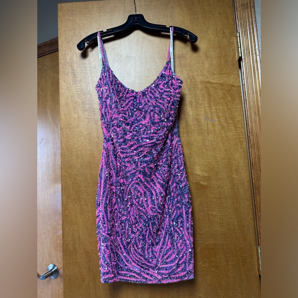 In good condition worn once has a little spot of sequence that has fell off